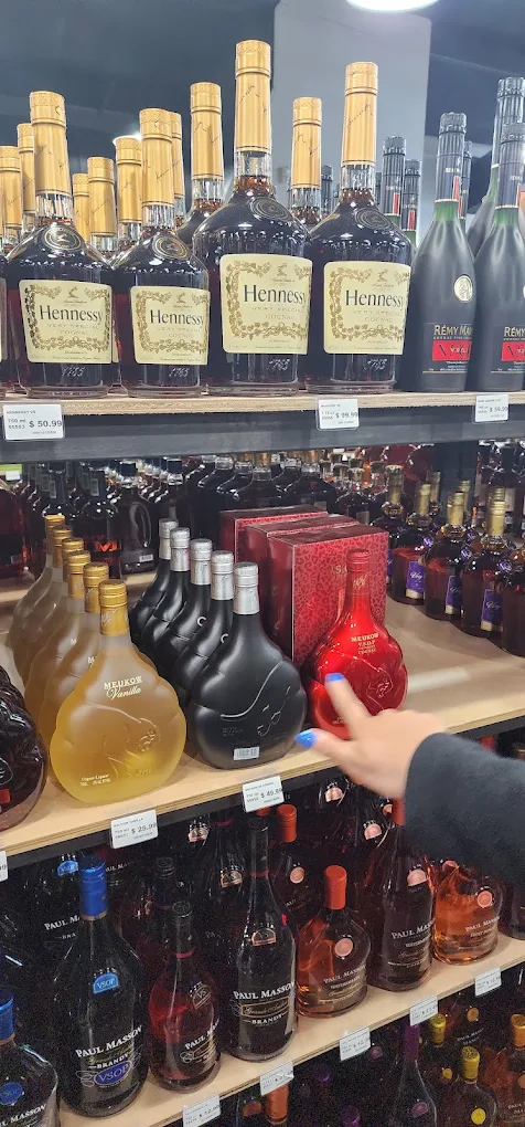 A Trenton Liquors team member helping a customer at the shelf