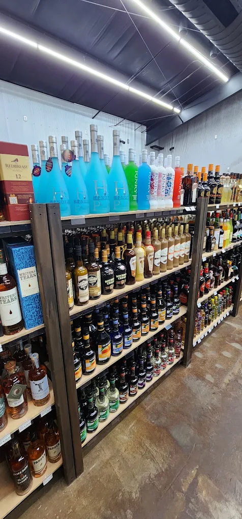 Wall of premium spirits and liqueurs at Trenton Liquors, including Redbreast and Hennessy